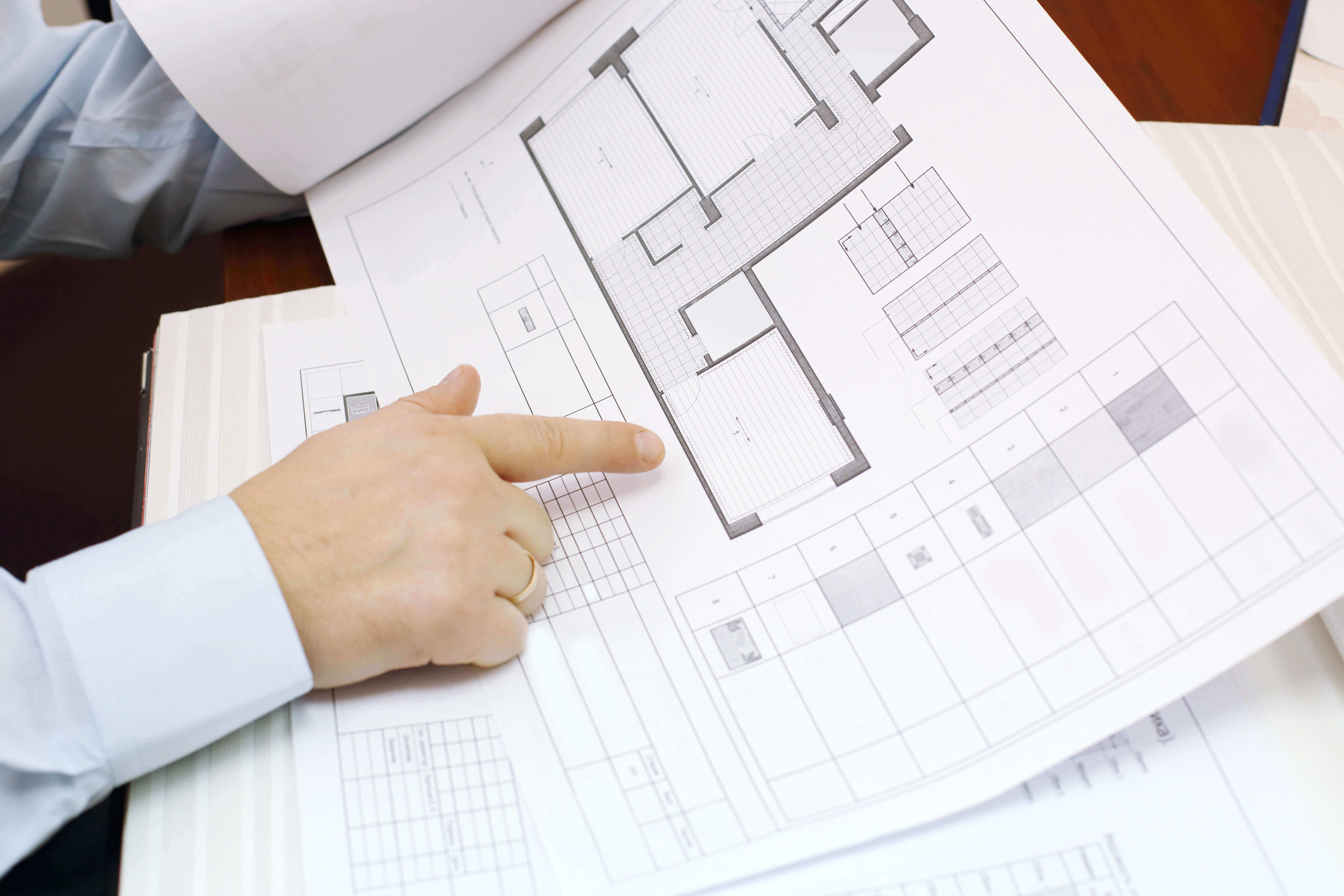 man looking at blueprints for home zoning purposes